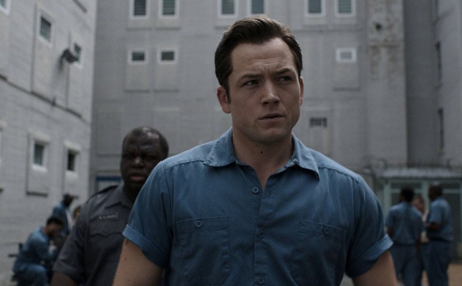 A still of Taron Egerton as Jimmy in a scene in jail.