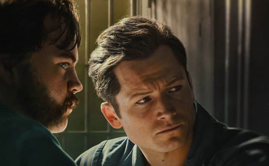 A still of Paul Walter Hauser and Taron Egerton as Hall and Keene sitting in jail.