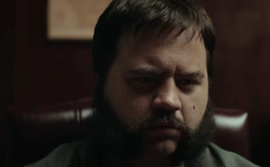A still of Paul Walter Hauser as Hall in jail.