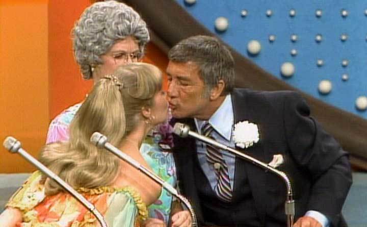 Richard Dawson leans into kiss a contestant.