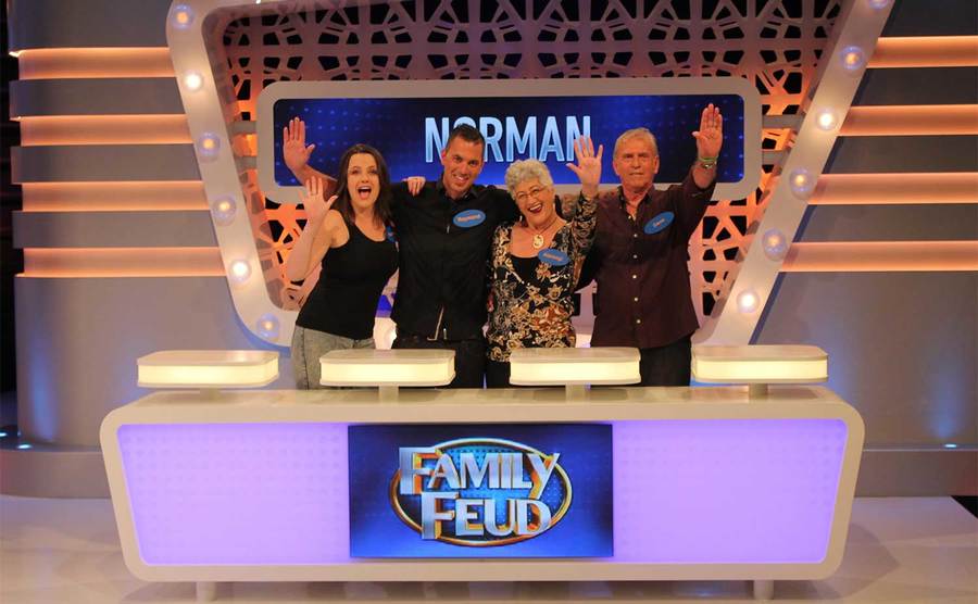 Contestants pose together on set.