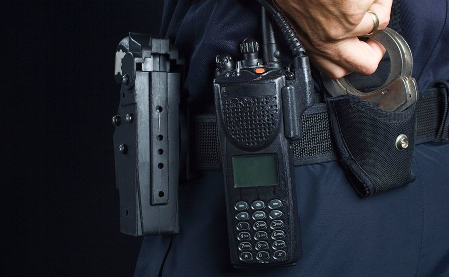 An image of a police officer with handcuffs.