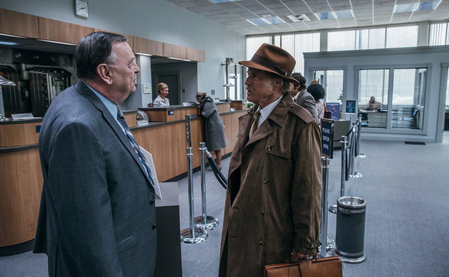 A movie still of Robert Redford in a scene in a bank.