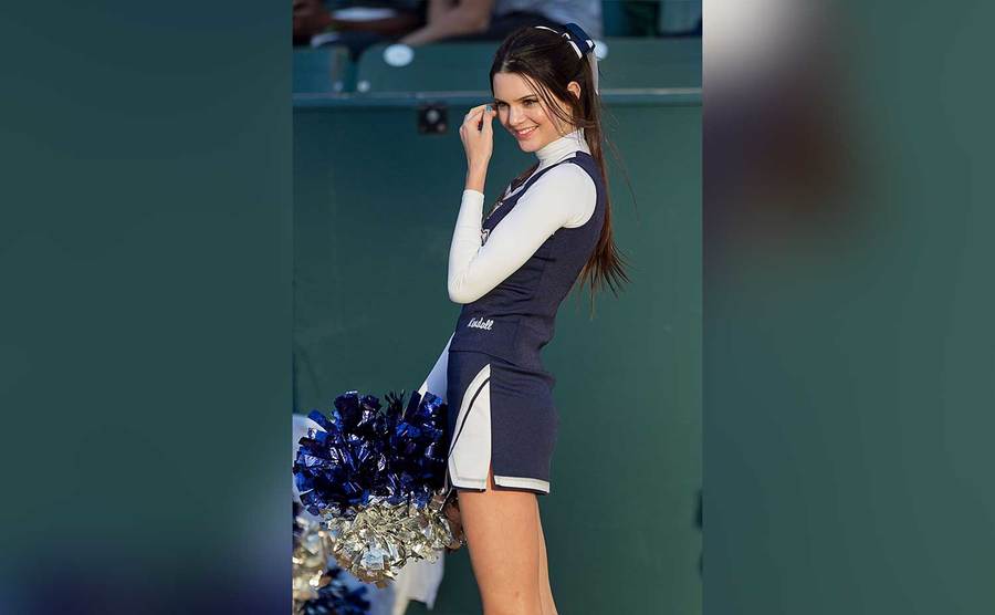 Kendall is in her cheerleading uniform.