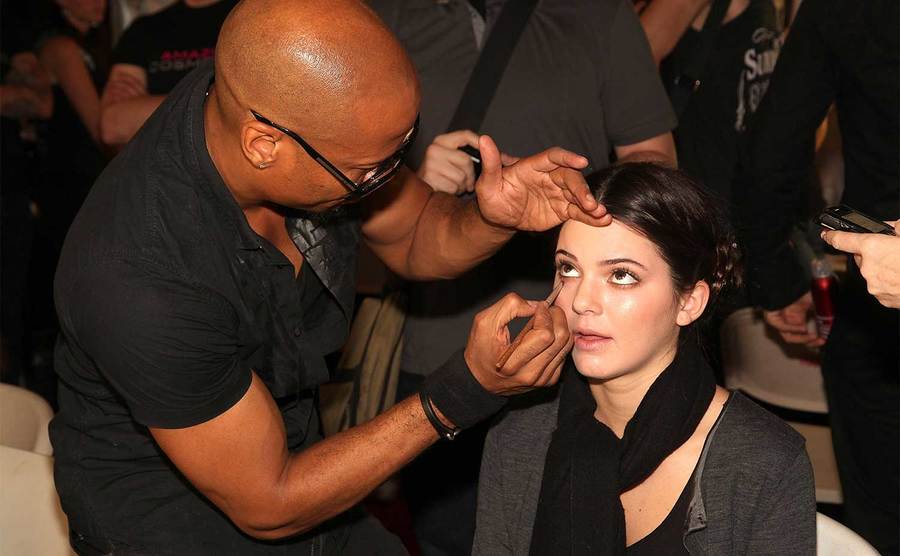 Kendall Jenner prepares backstage at the Evening Sherri Hill Spring 2012 fashion show.