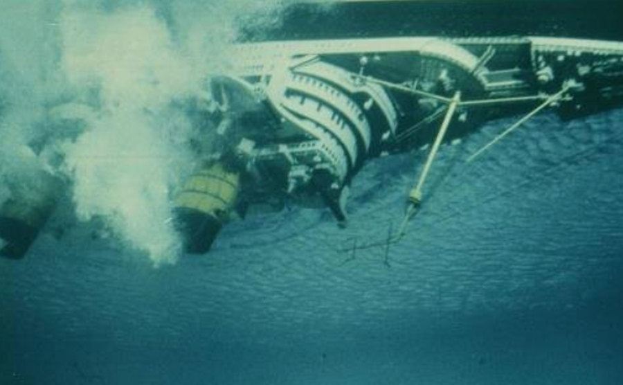 An image of a flipped boat in the sea.