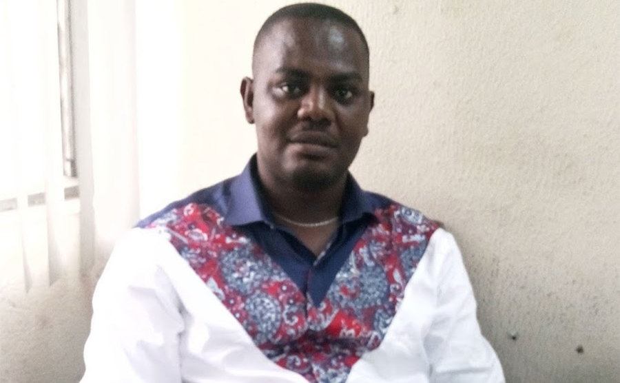 A portrait of Okene during an interview.