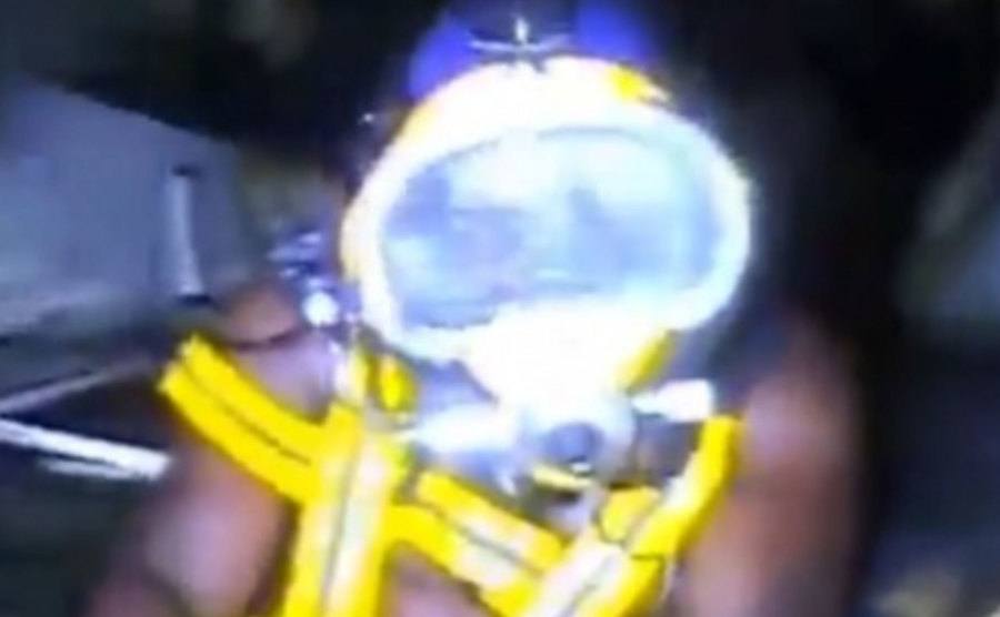 An image of Okene using a rebreather and an oxygen tank.