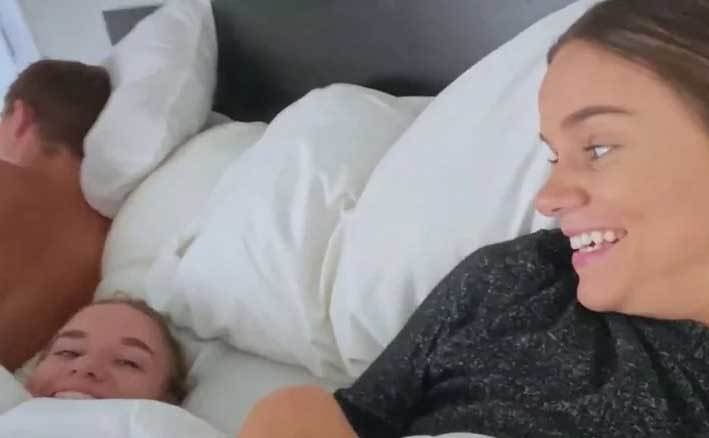 Brooke Johnston and Baylee Ring cuddle in bed together.