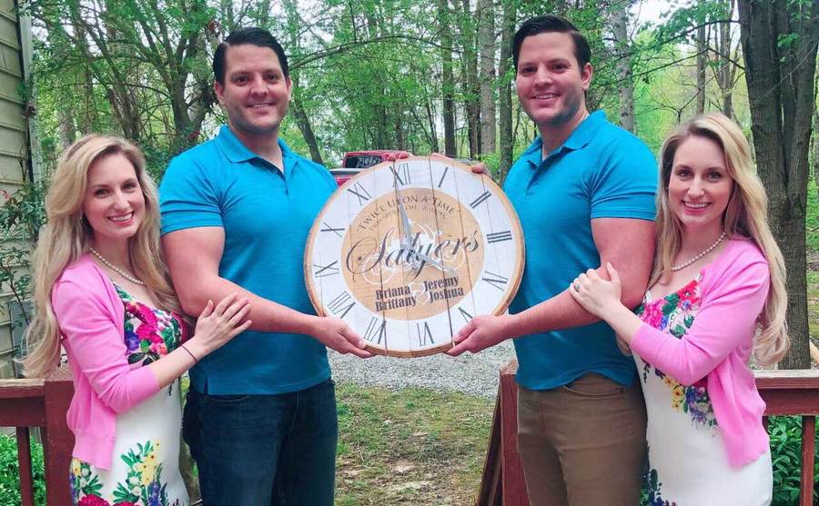 Brittany and Briana Dean, along with their husbands, pose on the front porch.