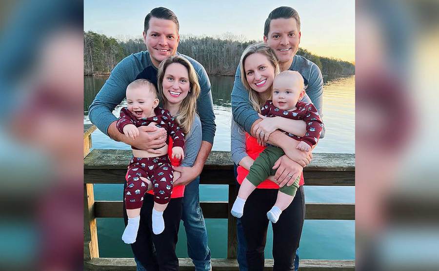 Brittany and Briana Dean pose with their families on the waterfront.