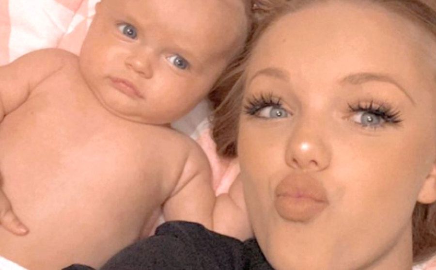 Reanna Cline takes a photo with her baby.