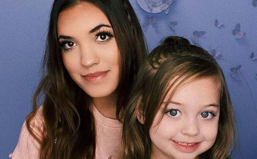 Chloe Mendoza takes a picture with her daughter.
