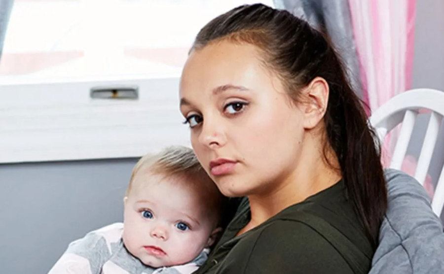 A portrait of one of the contestants with her baby.