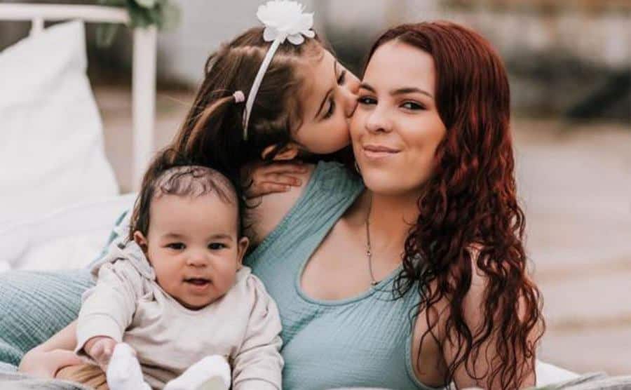 A former contestant poses with her children.