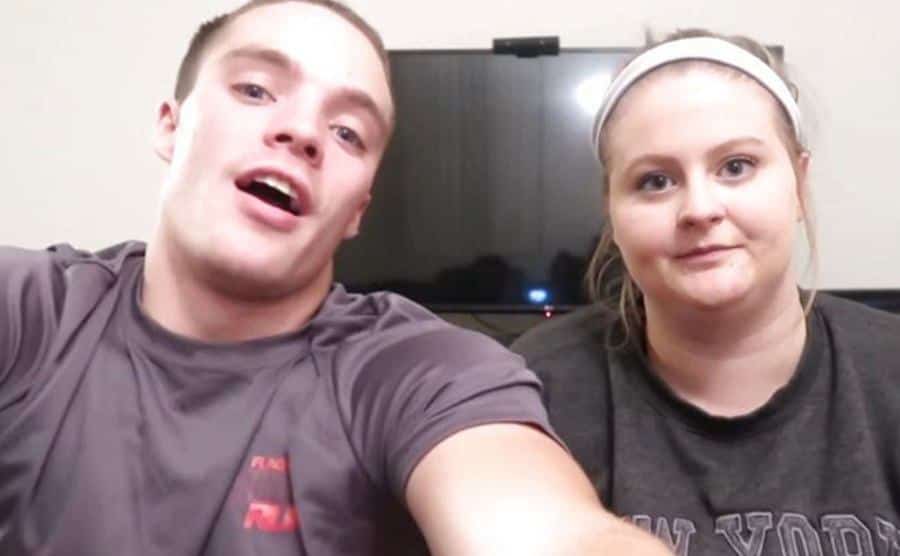 A still of Tylor Strawmyer and Lauren Barron talking to the camera.