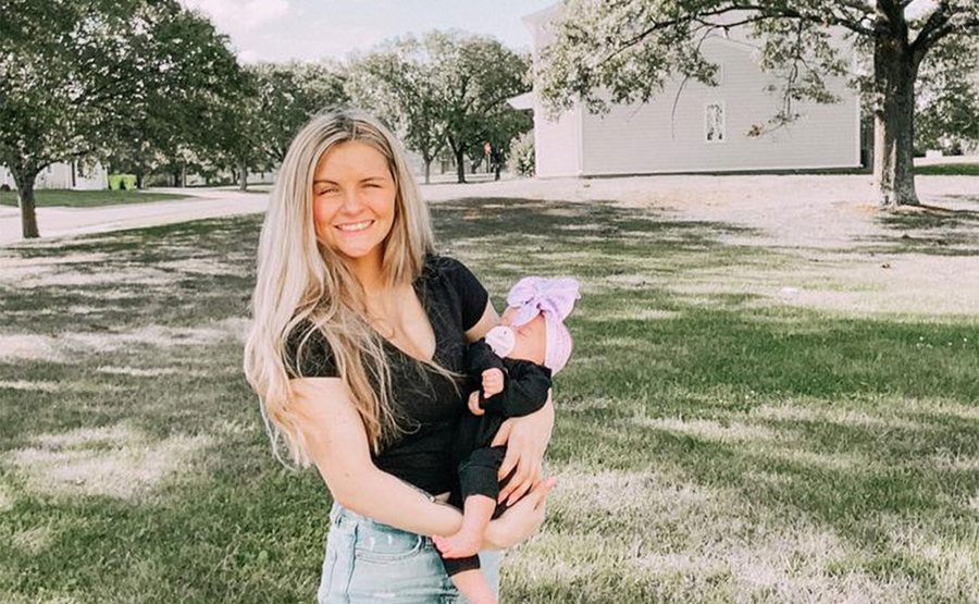 Tiarra poses for a portrait with her baby.