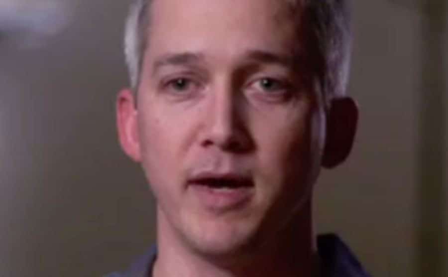 A still of Brad speaking during an interview.