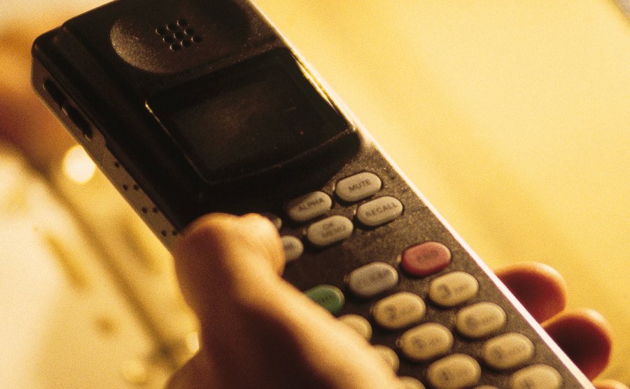 An image of a male’s hand holding a phone.
