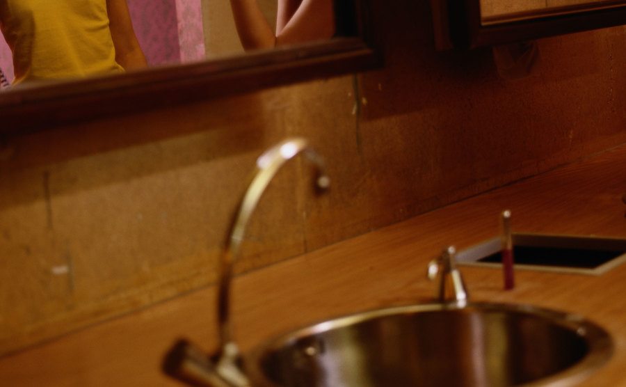 An image of two women speaking on the toilet.