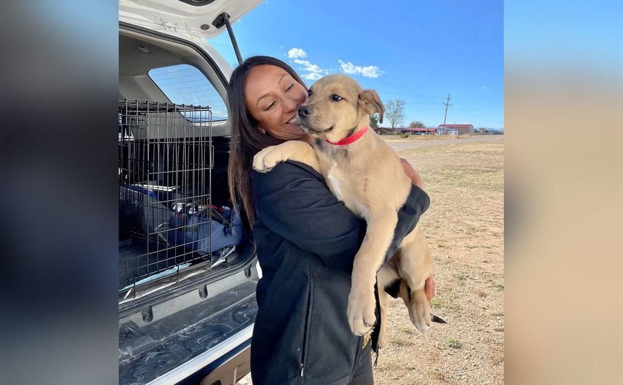 Española Humane volunteer Julie Martinez with one of Porky’s rescued pups. 