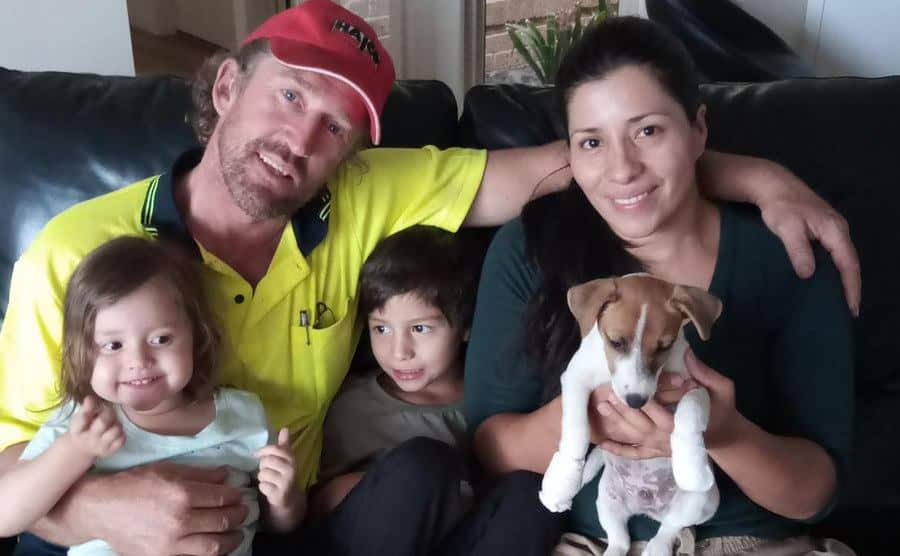 The Jones family poses with their new puppy at home. 