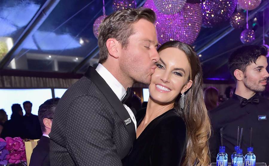 Hammer kisses Elizabeth Chambers on the cheek.