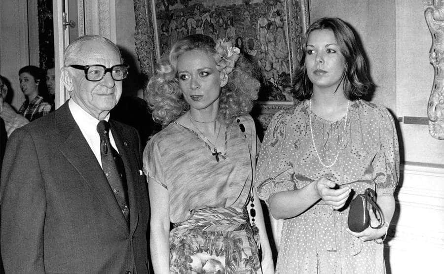 Armand Hammer poses with two women.