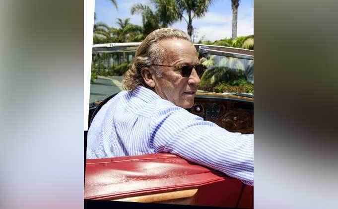 Michael Armand Hammer drives in a convertible.