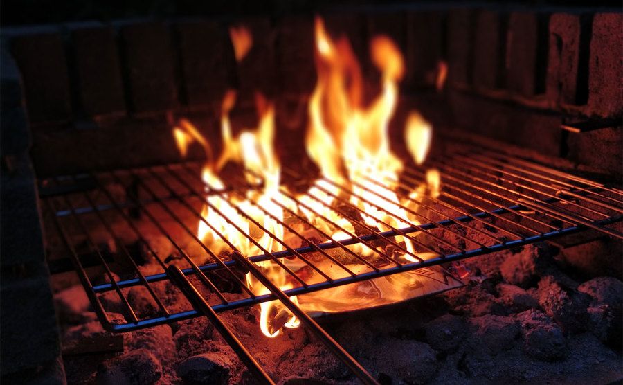 Fire rising from a barbecue.
