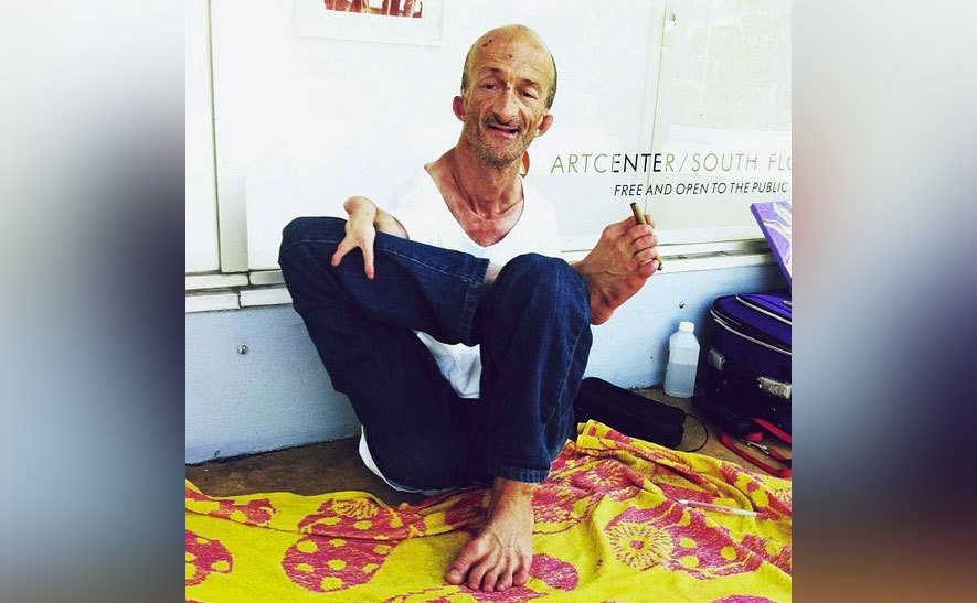 Jonathan Crenshaw holds something between his toes.