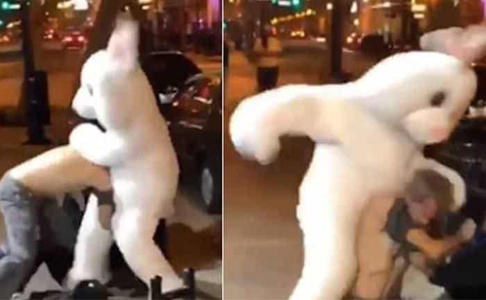 A man is having a fist fight with another man dressed as a bunny.