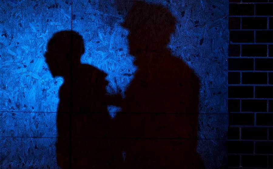 The shadows of a police officer and a man he has arrested.