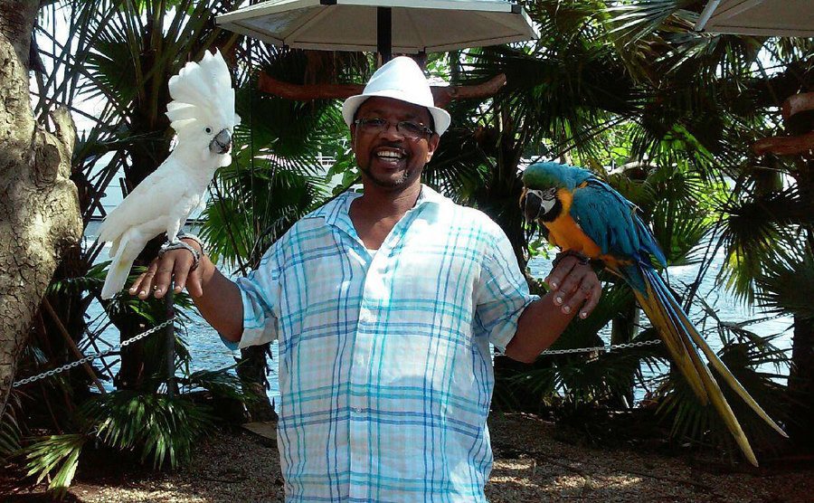 Arthur poses with some exotic birds while on vacation.