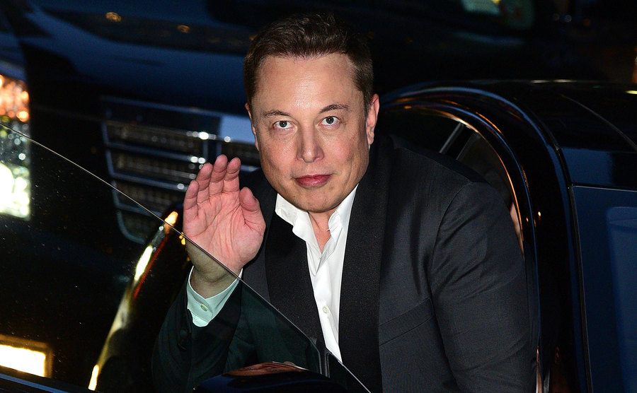 A photo of Musk entering his car.