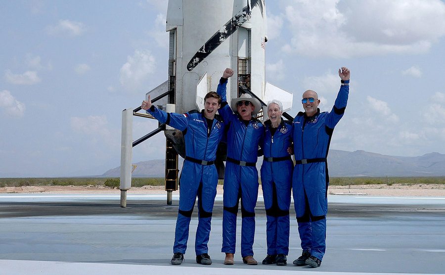 Oliver Daemen, Jeff Bezos, Wally Funk, and Mark Bezos pose for a picture after flying into space.