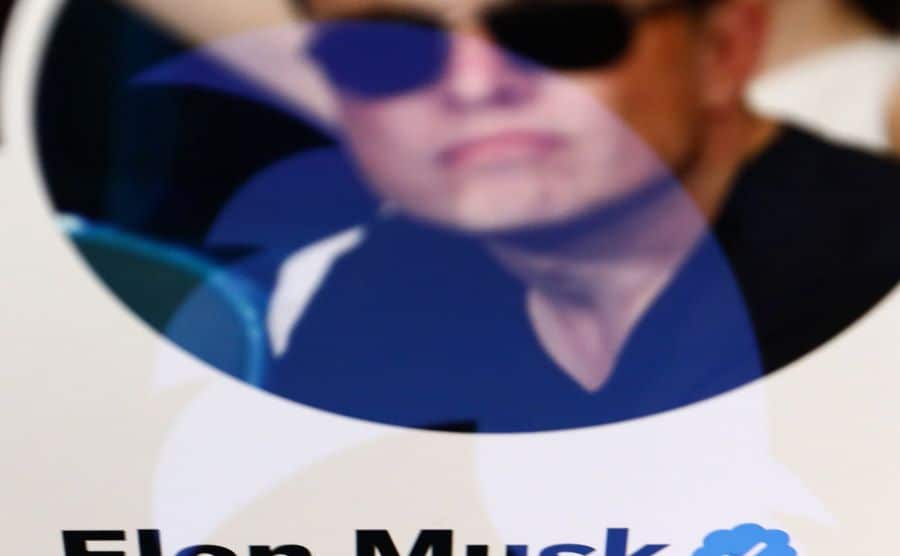 Elon Musk's Twitter account is displayed on a laptop screen.