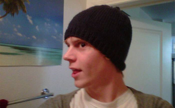 Peters shows off a knit hat he made.