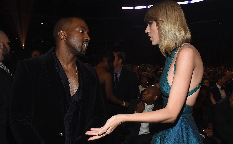 Kanye and Taylor are talking during an event.