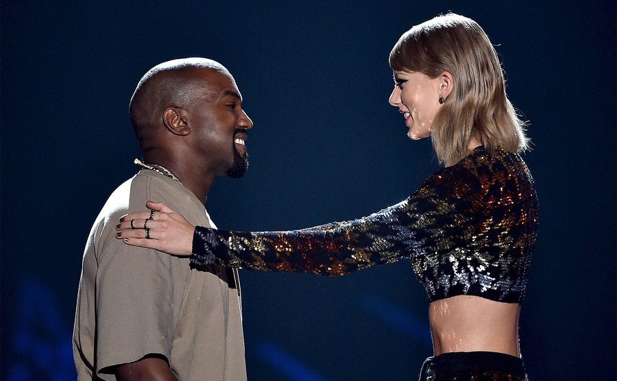 Kanye and Taylor stand on stage together.