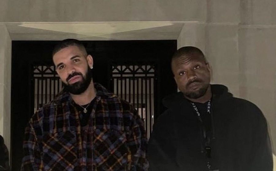 Drake and Kanye pose outside.
