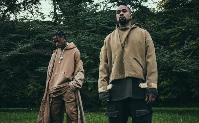 Travis Scott and Kanye West pose together.