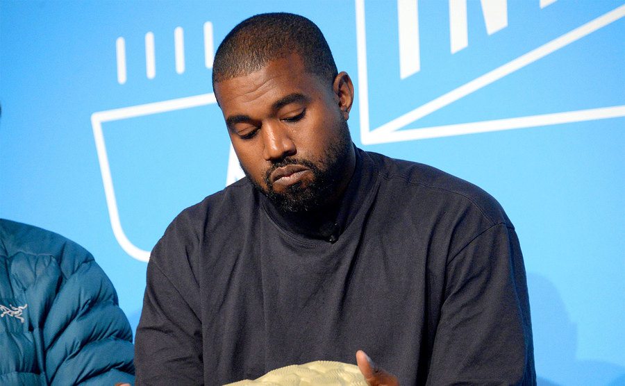 Kanye West speaks on stage.
