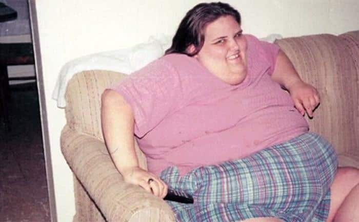 A photo of Susan Farmer watching tv at home.