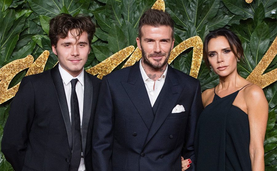 Brooklyn Beckham, David Beckham and Victoria Beckham arrive at The Fashion Awards.