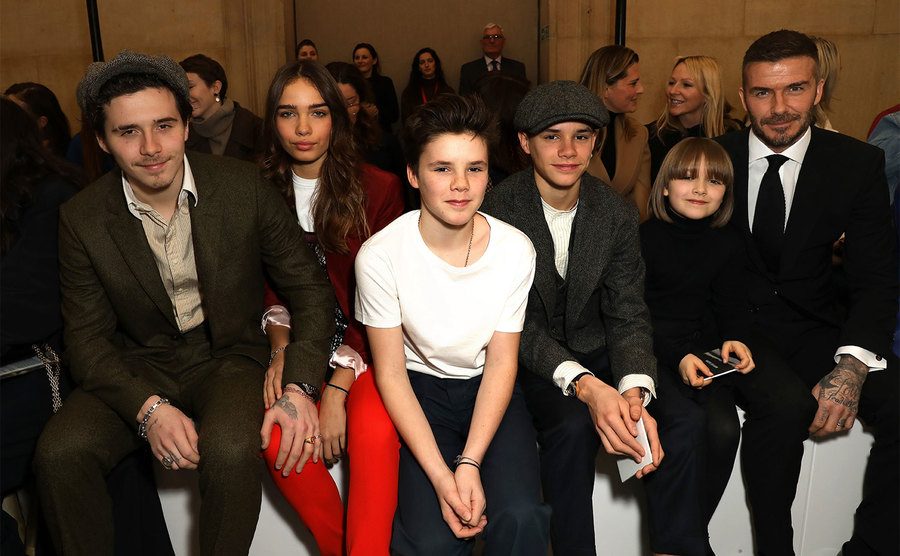 Brooklyn Beckham, Hana Cross, Cruz Beckham, Romeo Beckham, Harper Beckham, and David Beckham attend the Victoria Beckham show.