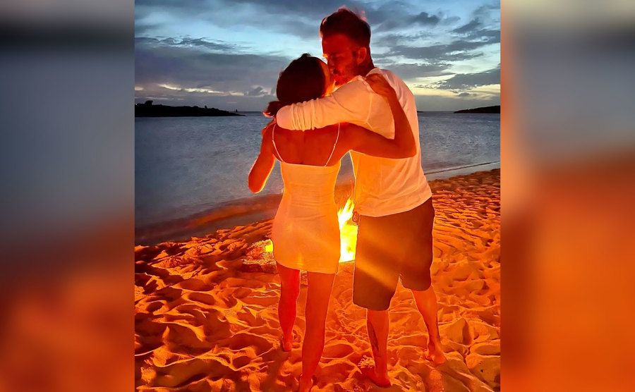 David and Victoria share a moment on the beach.