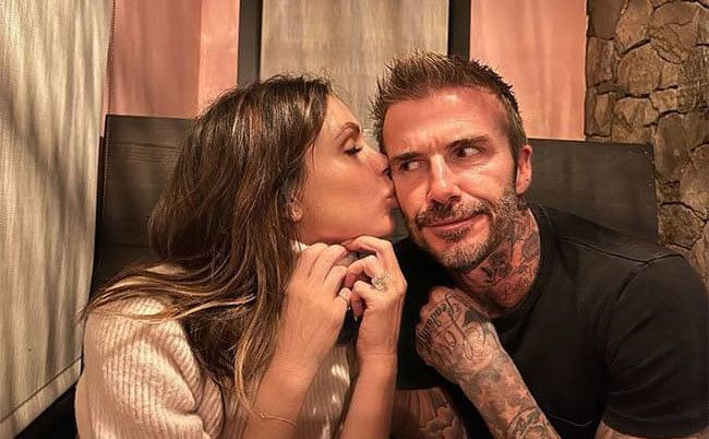 Victoria kisses David on the cheek.