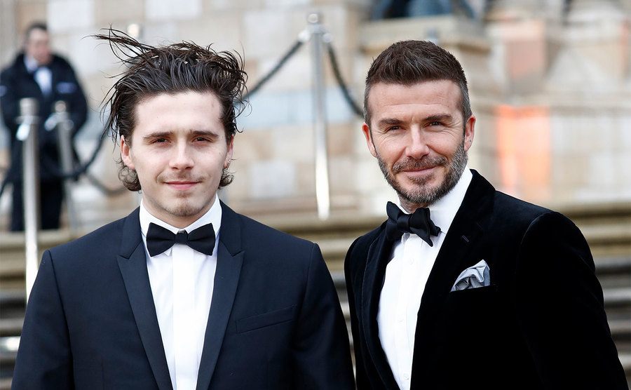 Brooklyn Beckham and David Beckham attend the
