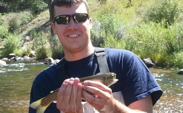 Chris Daugherty poses with a fish he caught.